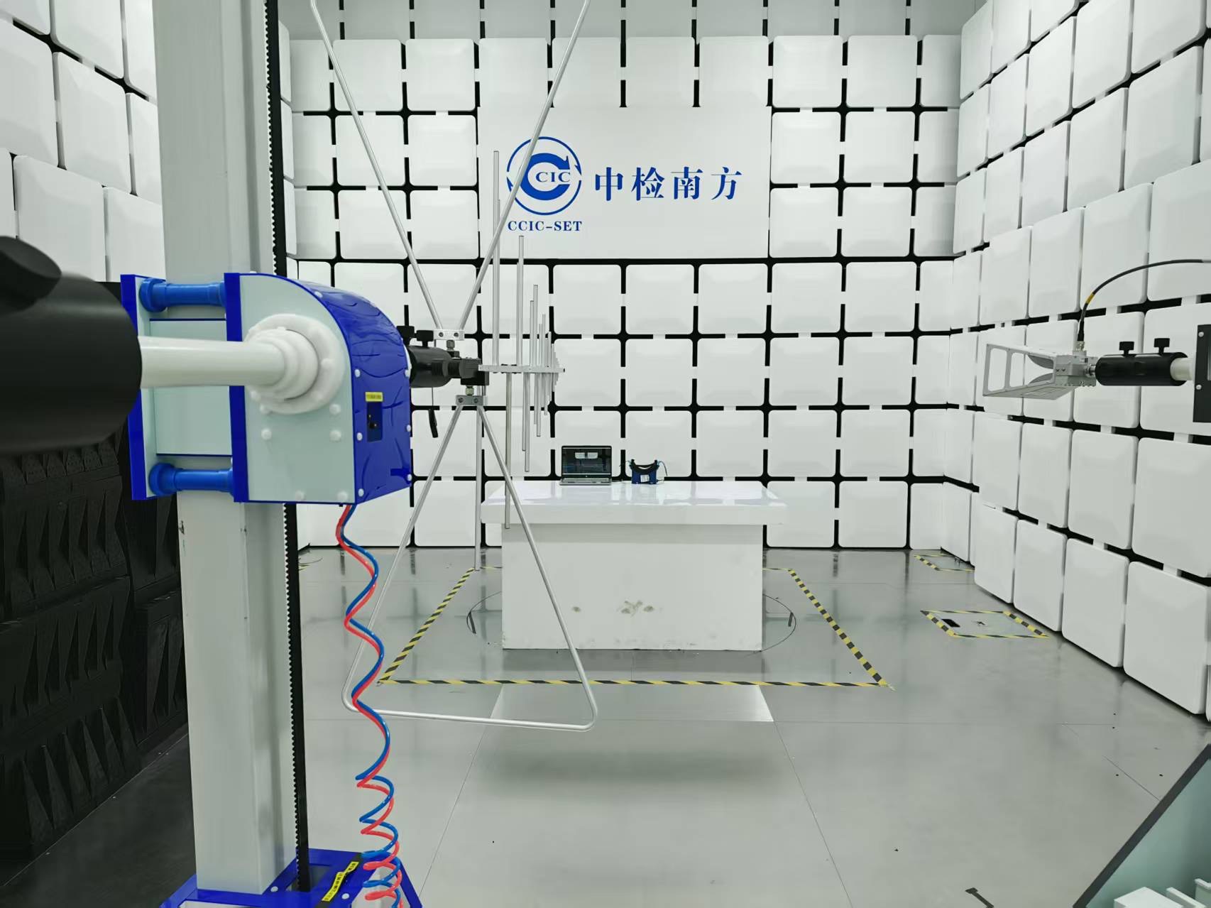 Technician testing a medical device in a soundproof room to ensure acoustic performance and precision.